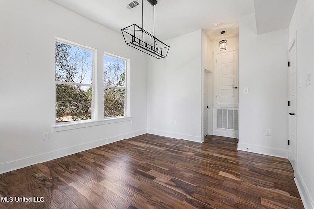 225 Magnolia Ave, Pass Christian, MS 39571 - unfurnished dining area featuring dark wood-style floors and baseboards