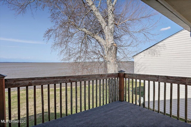 wooden terrace featuring a lawn