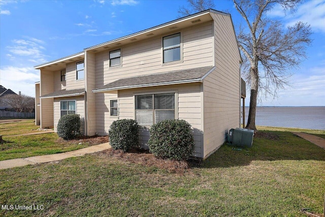 exterior space with a front lawn and a water view