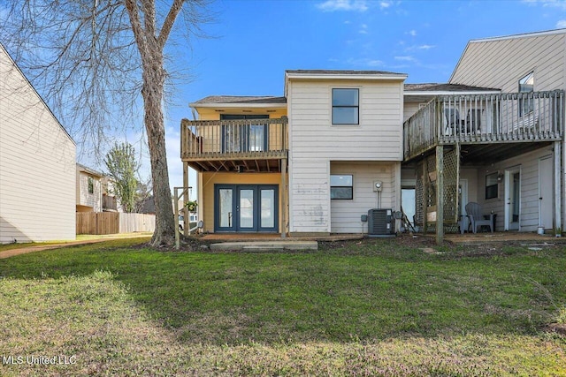 back of house with french doors, central AC, a lawn, and a balcony