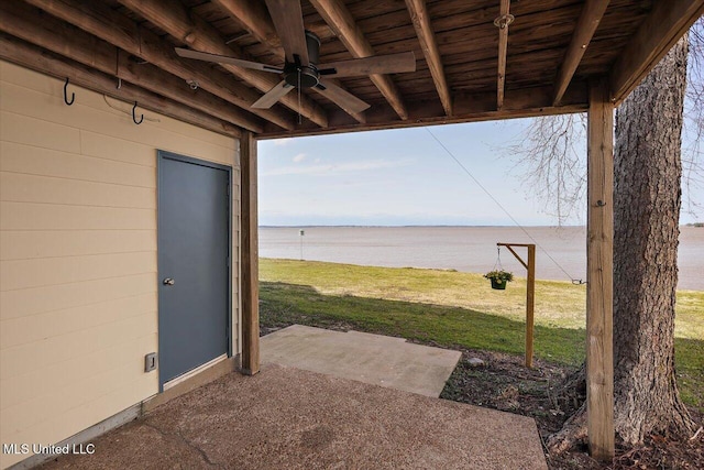 view of patio / terrace featuring ceiling fan and a water view