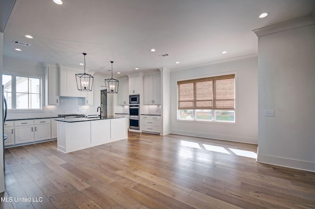 251 Westlake Cir, Madison, MS 39110 - kitchen with a sink, stainless steel appliances, dark countertops, a chandelier, and tasteful backsplash