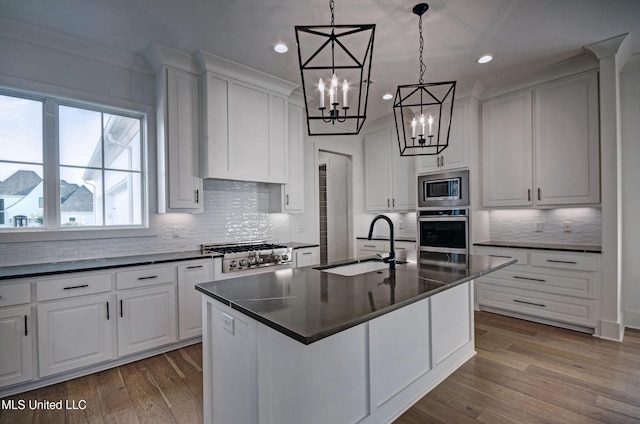 251 Westlake Cir, Madison, MS 39110 - kitchen featuring stainless steel appliances, dark countertops, a sink, a chandelier, and recessed lighting
