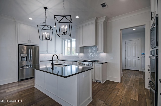 251 Westlake Cir, Madison, MS 39110 - kitchen featuring stainless steel appliances, dark countertops, dark wood-style floors, white cabinetry, and crown molding