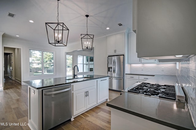 251 Westlake Cir, Madison, MS 39110 - kitchen featuring appliances with stainless steel finishes, a sink, dark countertops, decorative backsplash, and white cabinetry