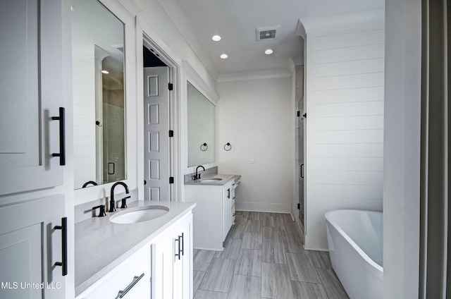 251 Westlake Cir, Madison, MS 39110 - bathroom with a stall shower, two vanities, a soaking tub, crown molding, and recessed lighting