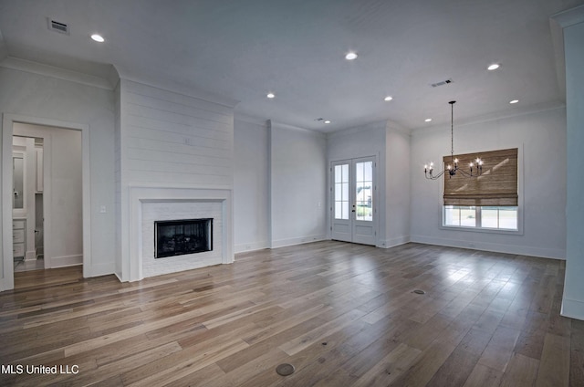 251 Westlake Cir, Madison, MS 39110 - unfurnished living room featuring a chandelier, a fireplace, crown molding, recessed lighting, and wood finished floors