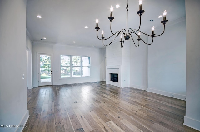 251 Westlake Cir, Madison, MS 39110 - unfurnished living room featuring crown molding, a chandelier, baseboards, wood finished floors, and recessed lighting