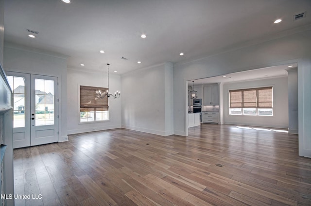 251 Westlake Cir, Madison, MS 39110 - unfurnished living room with a chandelier, ornamental molding, baseboards, wood finished floors, and french doors