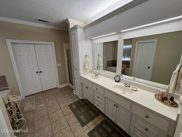 308 Barrington Cv, Byram, MS 39272 - full bath with crown molding, double vanity, a garden tub, a textured ceiling, and tile patterned floors