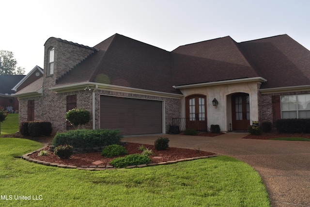 308 Barrington Cv, Byram, MS 39272 - view of front of property with french doors, driveway, a front yard, brick siding, and roof with shingles