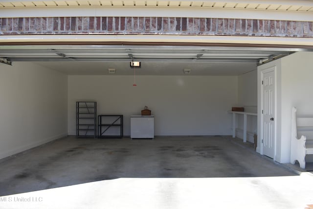 308 Barrington Cv, Byram, MS 39272 - garage featuring fridge, a garage door opener, and baseboards