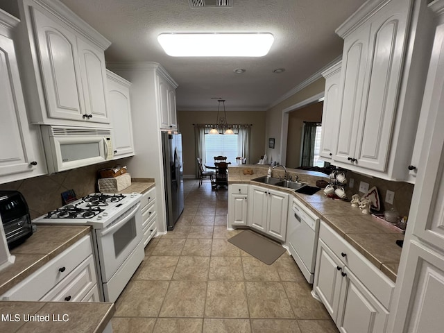 308 Barrington Cv, Byram, MS 39272 - kitchen with white appliances, backsplash, white cabinetry, and crown molding