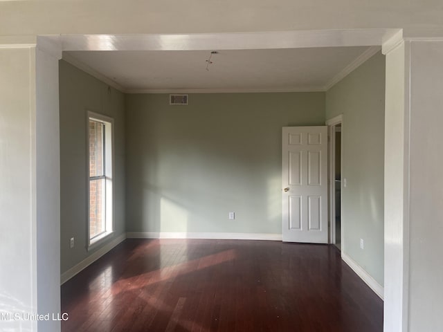 empty room with crown molding and dark hardwood / wood-style flooring