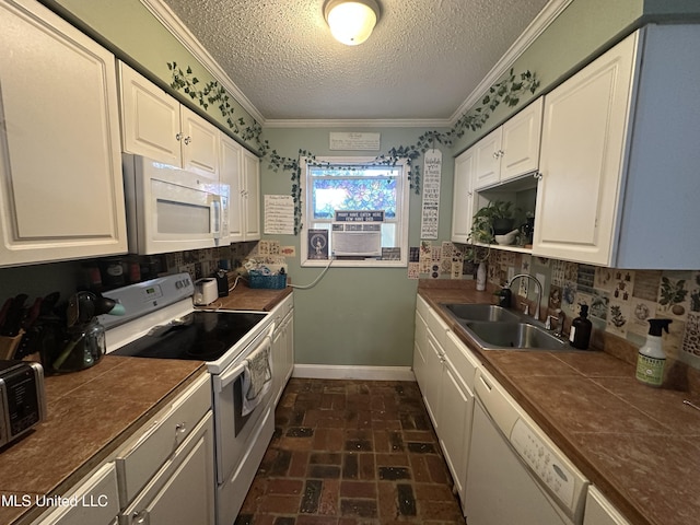 kitchen with white cabinetry, sink, crown molding, and white appliances