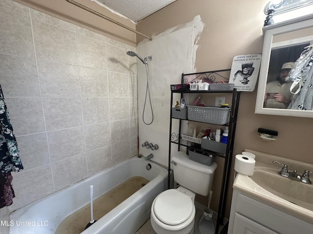 full bathroom with tiled shower / bath, vanity, a textured ceiling, and toilet