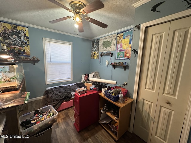 bedroom with crown molding, ceiling fan, dark hardwood / wood-style floors, and a textured ceiling