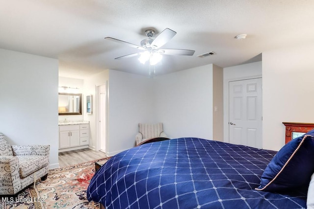 3109 Breezy Hill Ln, Ocean Springs, MS 39564 - bedroom with wood finished floors, a ceiling fan, connected bathroom, and baseboards
