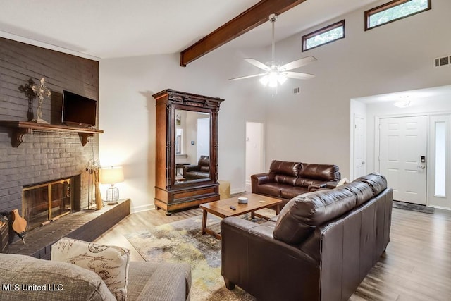 3109 Breezy Hill Ln, Ocean Springs, MS 39564 - living area with wood finished floors, a ceiling fan, a fireplace, baseboards, and beamed ceiling