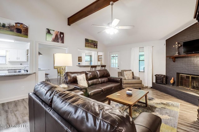 3109 Breezy Hill Ln, Ocean Springs, MS 39564 - living area featuring light wood-style flooring, a ceiling fan, a brick fireplace, beamed ceiling, and high vaulted ceiling