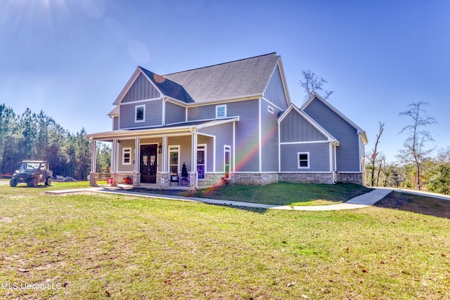 view of front of property with covered porch and a front yard