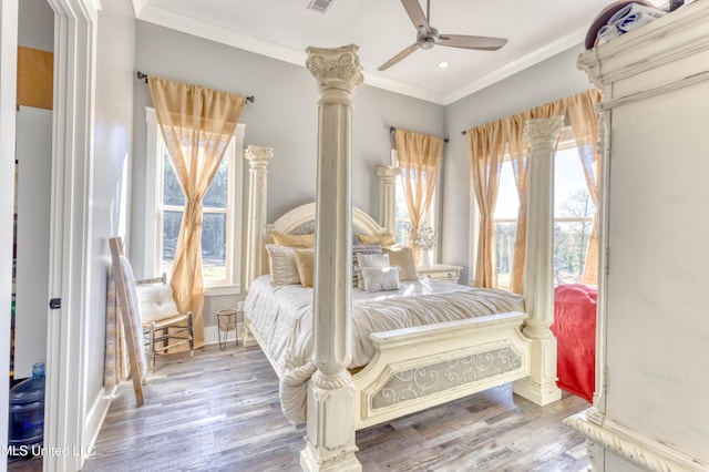 bedroom featuring hardwood / wood-style flooring, ceiling fan, and ornamental molding