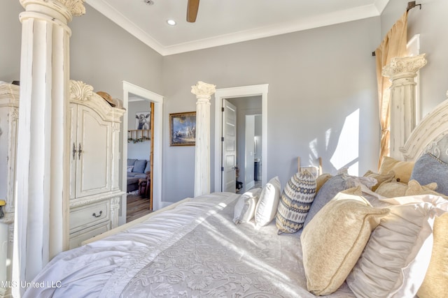 bedroom with ensuite bath, ornate columns, ceiling fan, and crown molding