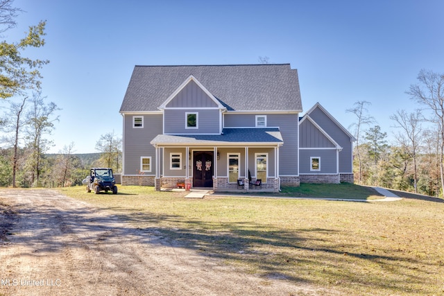 craftsman inspired home featuring a porch and a front lawn