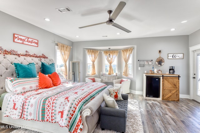 bedroom featuring ceiling fan, wood-type flooring, and fridge