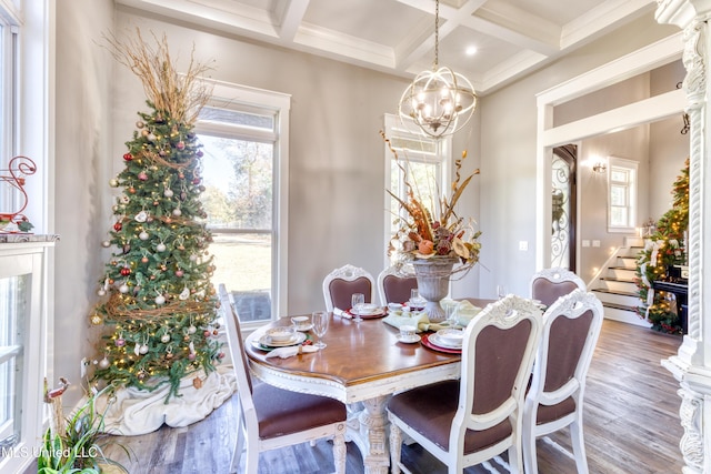 dining area featuring beamed ceiling, hardwood / wood-style floors, an inviting chandelier, and coffered ceiling