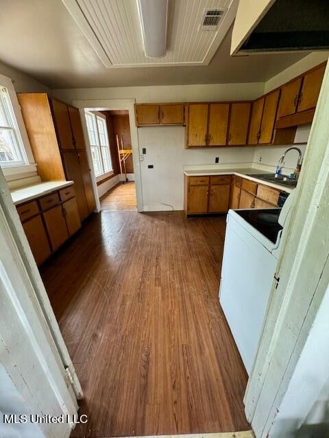 kitchen with white range with electric cooktop, sink, plenty of natural light, and dark hardwood / wood-style floors