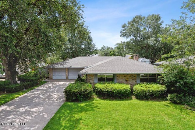 ranch-style house featuring a garage and a front lawn