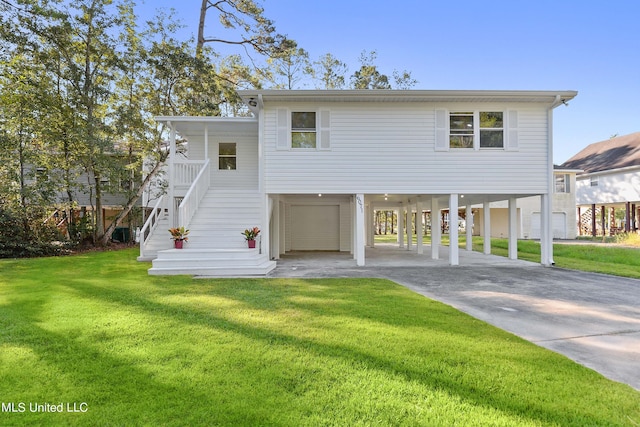 6071 Comanche St, Kiln, MS 39556 - coastal home featuring a carport, driveway, stairs, a front lawn, and a garage