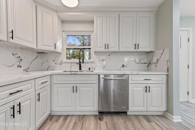 6071 Comanche St, Kiln, MS 39556 - kitchen with dishwasher, a sink, light wood-style floors, and white cabinets