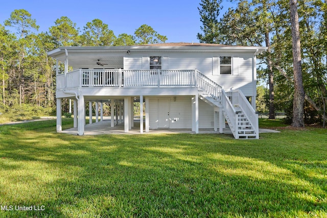6071 Comanche St, Kiln, MS 39556 - rear view of house featuring stairway, ceiling fan, a lawn, a patio area, and a wooden deck