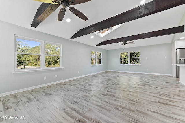 6071 Comanche St, Kiln, MS 39556 - unfurnished living room with ceiling fan, a skylight, baseboards, recessed lighting, and light wood-style floors