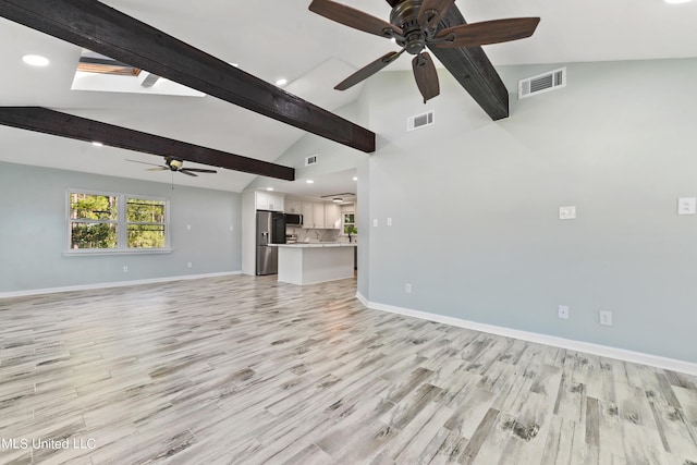 6071 Comanche St, Kiln, MS 39556 - unfurnished living room featuring a ceiling fan, baseboards, light wood-style flooring, recessed lighting, and a skylight