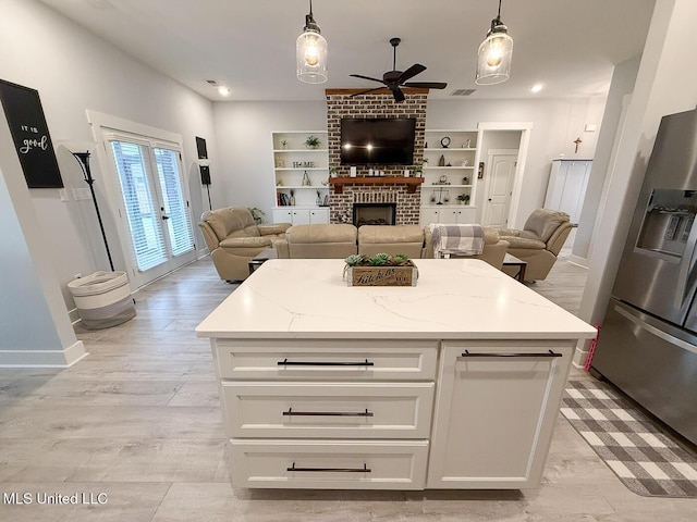 2290 Loisy Blvd, Hernando, MS 38632 - kitchen featuring stainless steel refrigerator with ice dispenser, open floor plan, a ceiling fan, and a fireplace