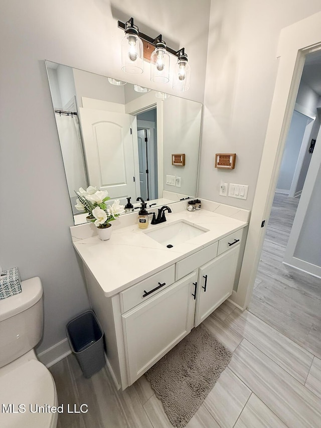 2290 Loisy Blvd, Hernando, MS 38632 - bathroom with toilet, vanity, and baseboards