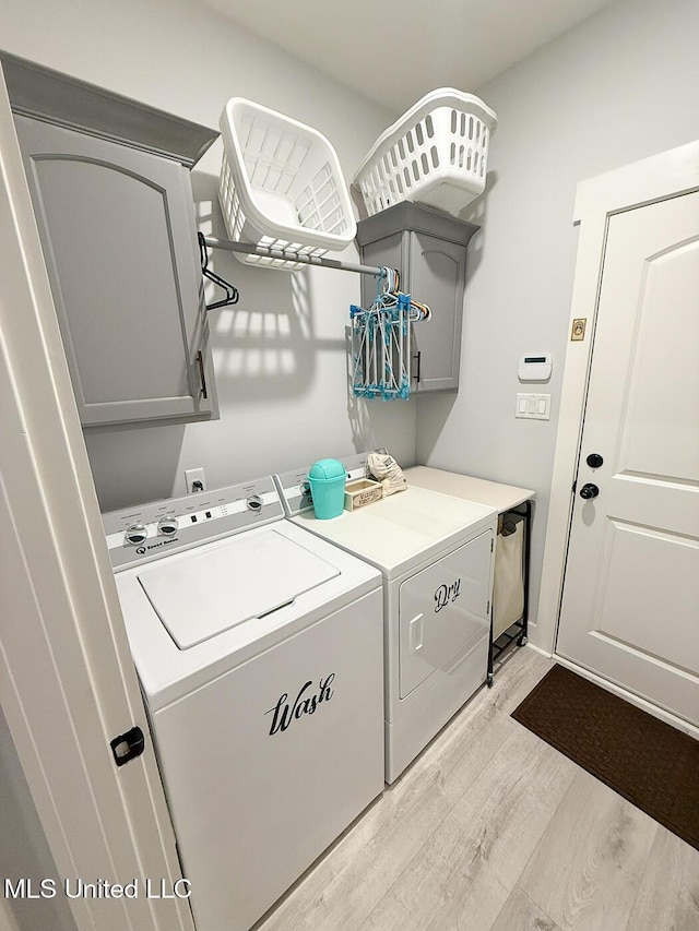 2290 Loisy Blvd, Hernando, MS 38632 - washroom with cabinet space, separate washer and dryer, and light wood-style floors
