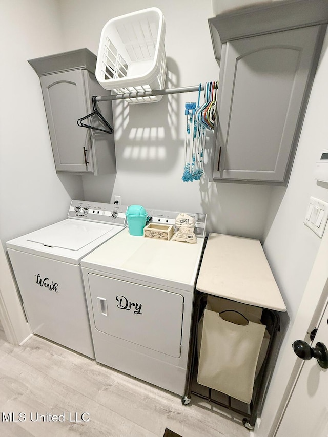 2290 Loisy Blvd, Hernando, MS 38632 - laundry room featuring washer and clothes dryer, cabinet space, and light wood finished floors