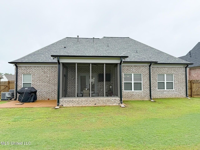 2290 Loisy Blvd, Hernando, MS 38632 - rear view of house featuring brick siding, central AC unit, a sunroom, and roof with shingles
