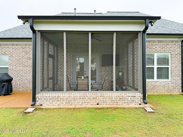 2290 Loisy Blvd, Hernando, MS 38632 - rear view of property featuring brick siding, a sunroom, roof with shingles, and a lawn