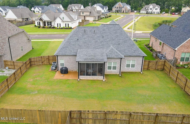 2290 Loisy Blvd, Hernando, MS 38632 - rear view of house featuring a sunroom, a residential view, a shingled roof, central AC unit, and brick siding