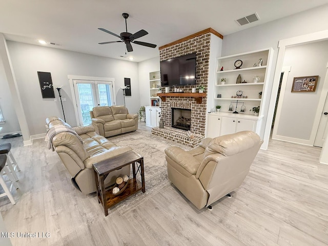 2290 Loisy Blvd, Hernando, MS 38632 - living area featuring light wood finished floors, a ceiling fan, baseboards, a brick fireplace, and recessed lighting
