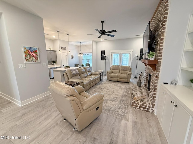 2290 Loisy Blvd, Hernando, MS 38632 - living room with a ceiling fan, a fireplace, light wood-style floors, and baseboards