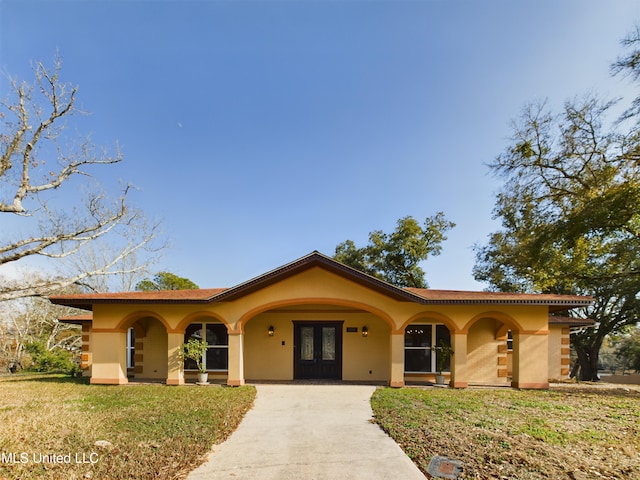 view of front of house featuring french doors and a front lawn