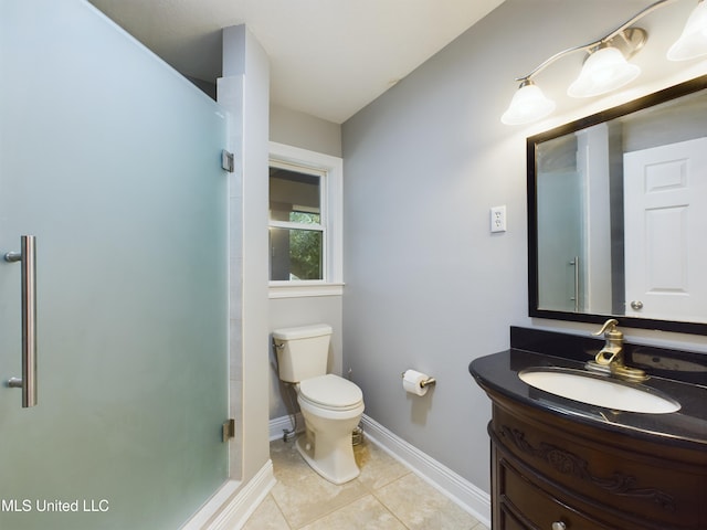 bathroom featuring vanity, a shower with door, tile patterned floors, and toilet