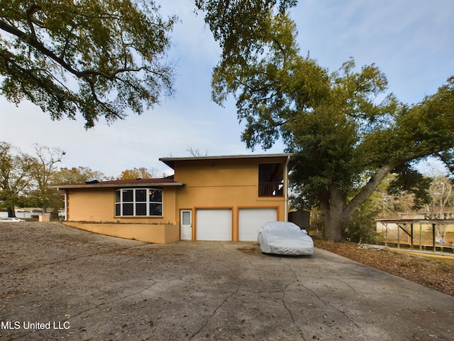 view of front of home featuring a balcony and a garage