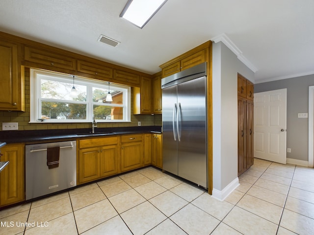 kitchen featuring light tile patterned flooring, sink, crown molding, stainless steel appliances, and backsplash